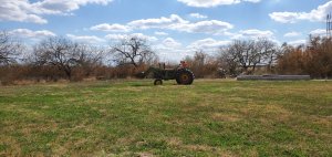 John Deere tractor in an open field.